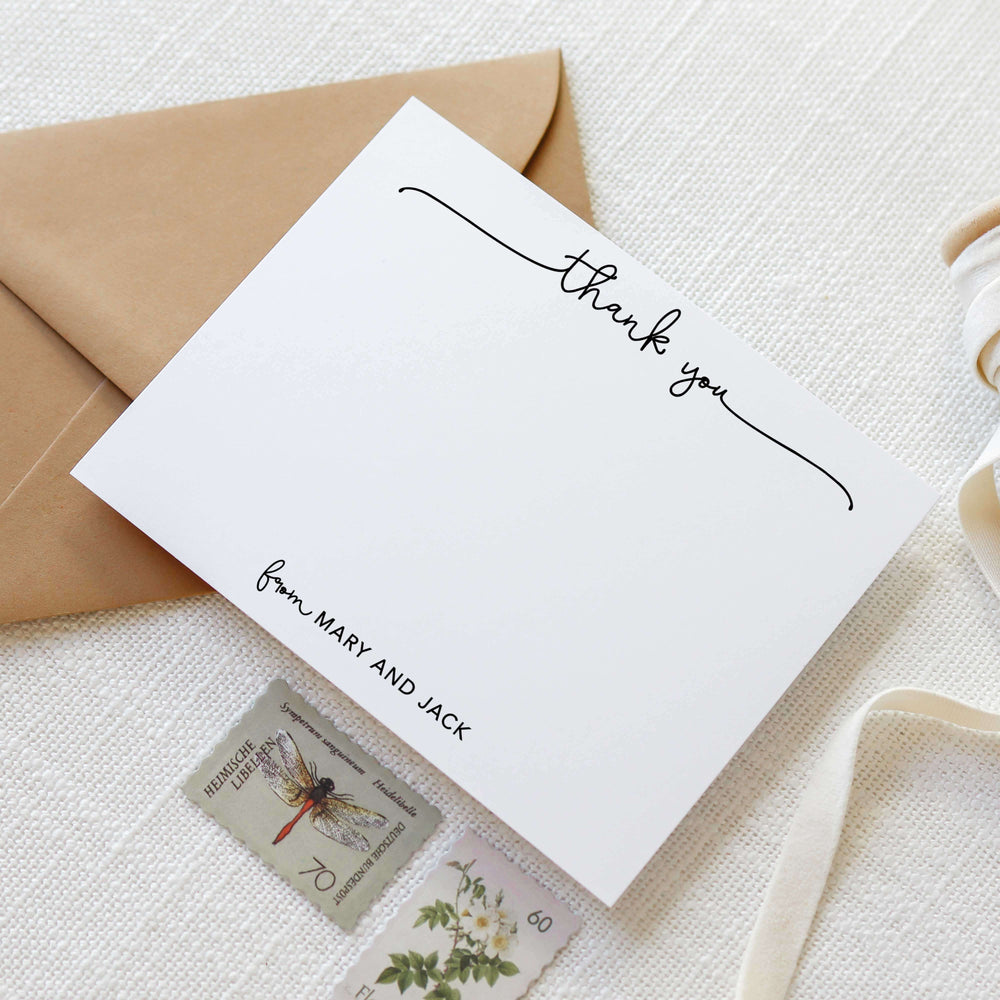 Harvest A2 personalized thank you flat note card with calligraphy script and custom names, kraft envelope, and vintage postage stamps on linen background