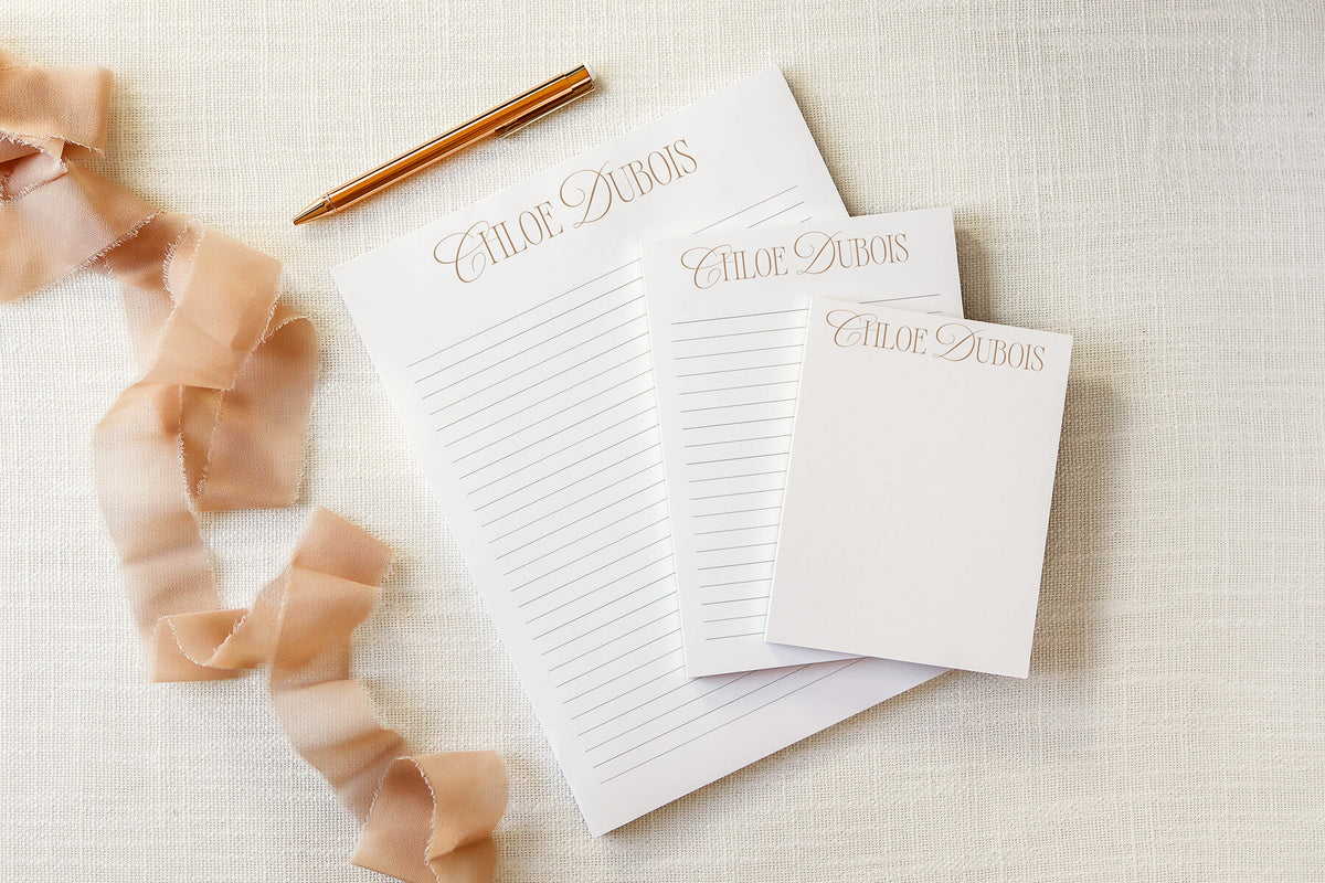 Personalized notepads with custom calligraphy name on lined stationery with gold pen and satin ribbon