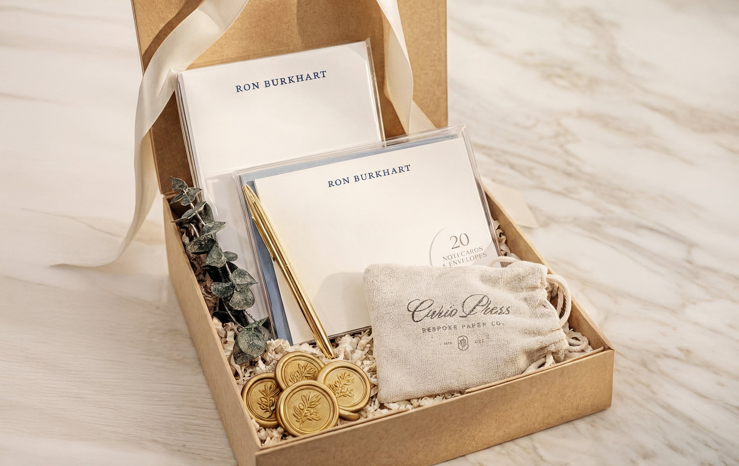 Personalized stationery gift box with custom note cards, gold wax seals, eucalyptus sprig, and Curio Press drawstring pouch