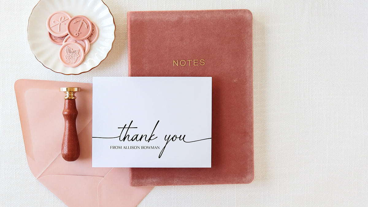 Custom thank you note card with calligraphy script on velvet notebook with pink wax seals and brass stamp